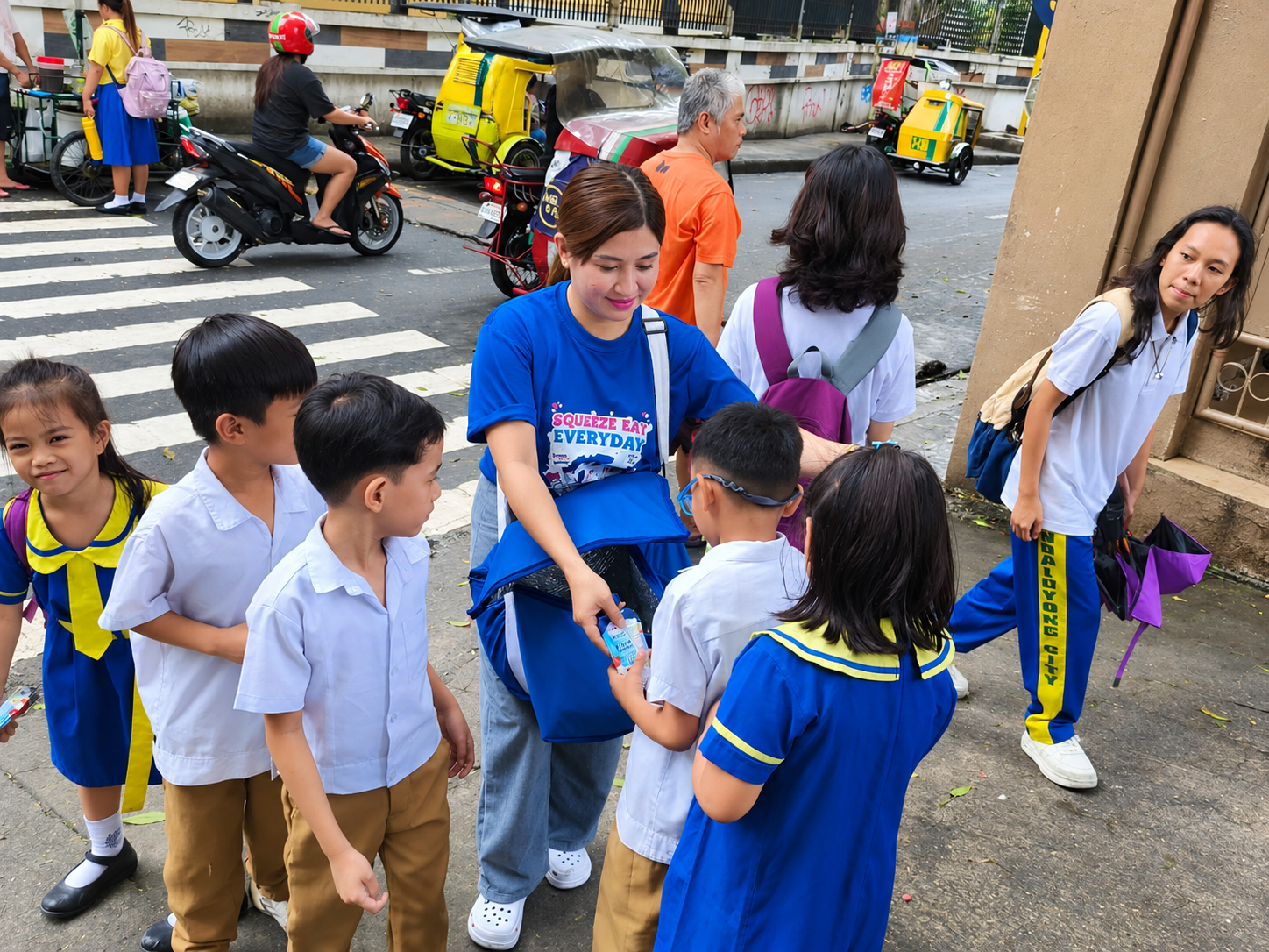 Cimory representative handing product samples to students during a school activation